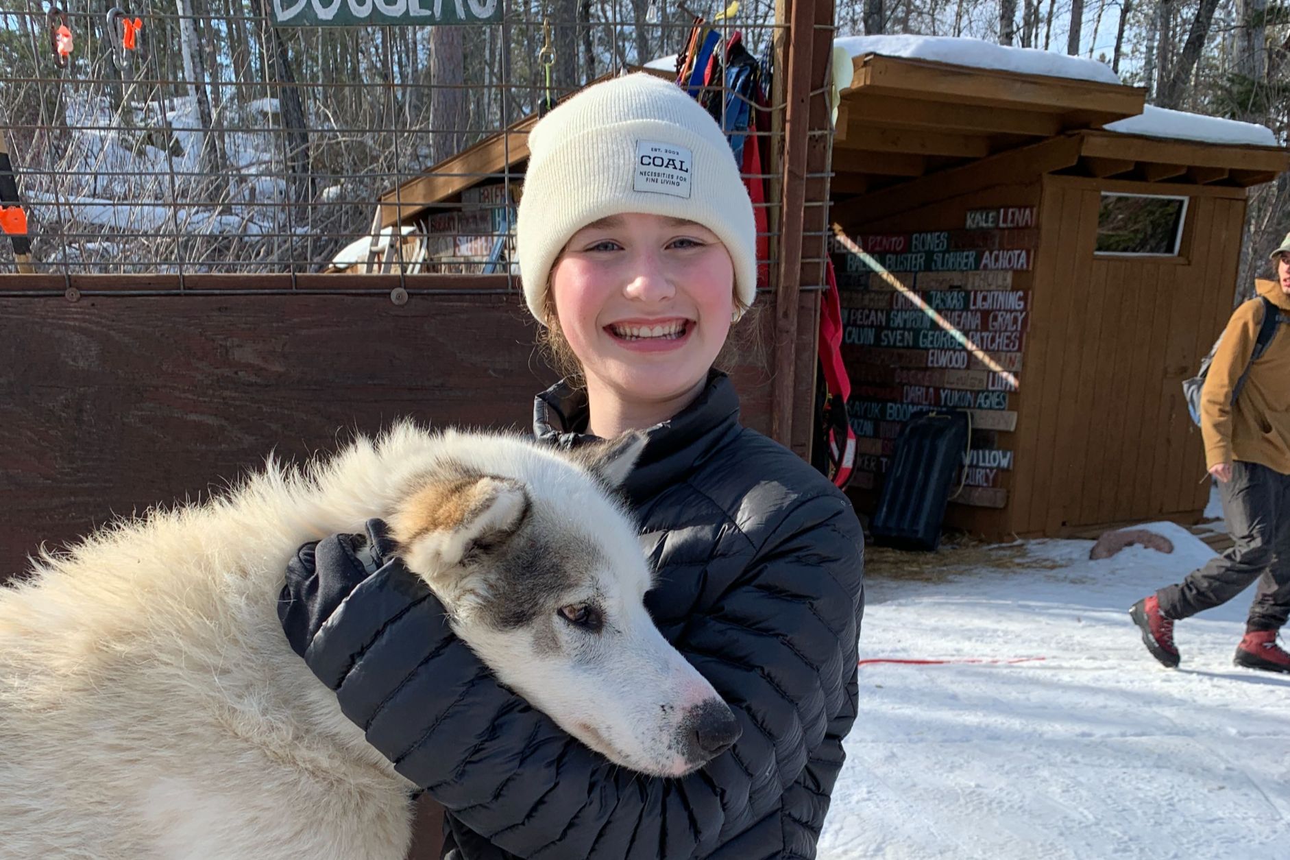 Student hugging a dog
